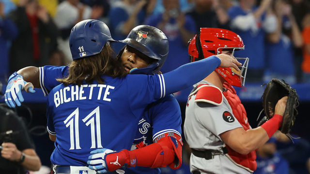 TORONTO, ON - SEPTEMBER 30 - Bo Bichette embraces Toronto Blue Jays first baseman Vladimir Guerrero Jr. (27) who hit a two run home run in the third inning as the Toronto Blue Jays play the Boston Red Sox at Rogers Centre in Toronto. September 30, 2022. Each year, in Canada, September 30 marks the National Day for Truth and Reconciliation. The day honours the children who never returned home and Survivors of residential schools, as well as their families and communities. (Steve Russell/Toronto Star via Getty Images)