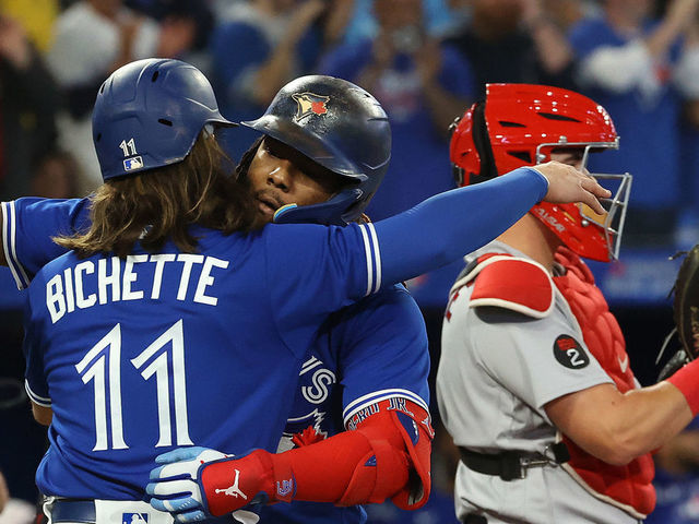 TORONTO, ON - SEPTEMBER 30 - Bo Bichette embraces Toronto Blue Jays first baseman Vladimir Guerrero Jr. (27) who hit a two run home run in the third inning as the Toronto Blue Jays play the Boston Red Sox at Rogers Centre in Toronto. September 30, 2022. Each year, in Canada, September 30 marks the National Day for Truth and Reconciliation. The day honours the children who never returned home and Survivors of residential schools, as well as their families and communities. (Steve Russell/Toronto Star via Getty Images)
