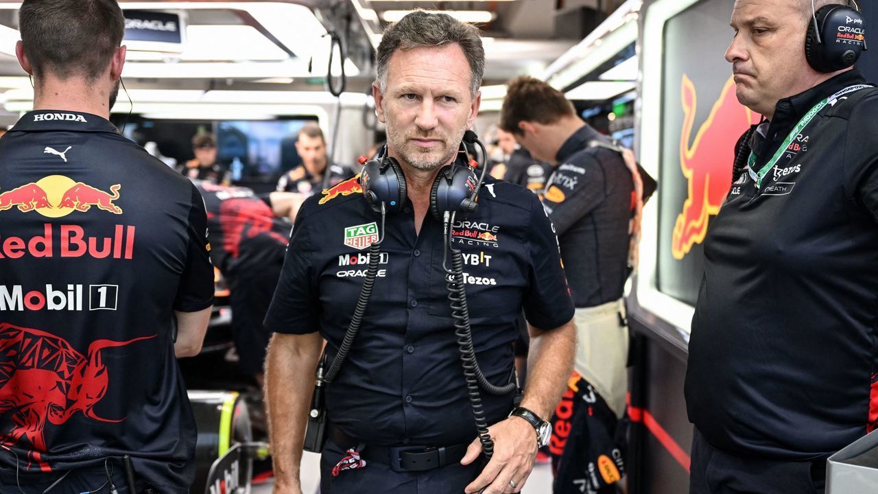 Red Bull Racing's British team chief Christian Horner (C) prepares before a practice session ahead of the Formula One Singapore Grand Prix night race at the Marina Bay Street Circuit in Singapore on October 1, 2022.