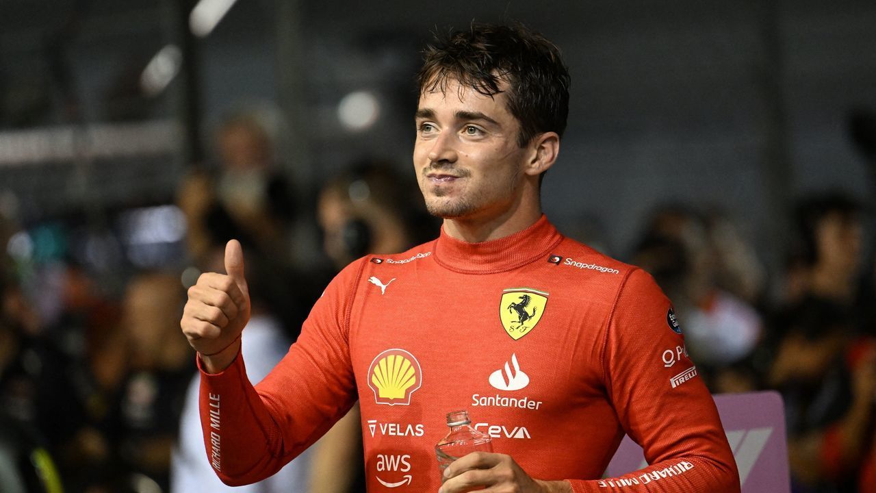 Ferrari's Monegasque driver Charles Leclerc reacts after taking the pole position after the qualifying session ahead of the Formula One Singapore Grand Prix night race at the Marina Bay Street Circuit in Singapore on October 1, 2022.