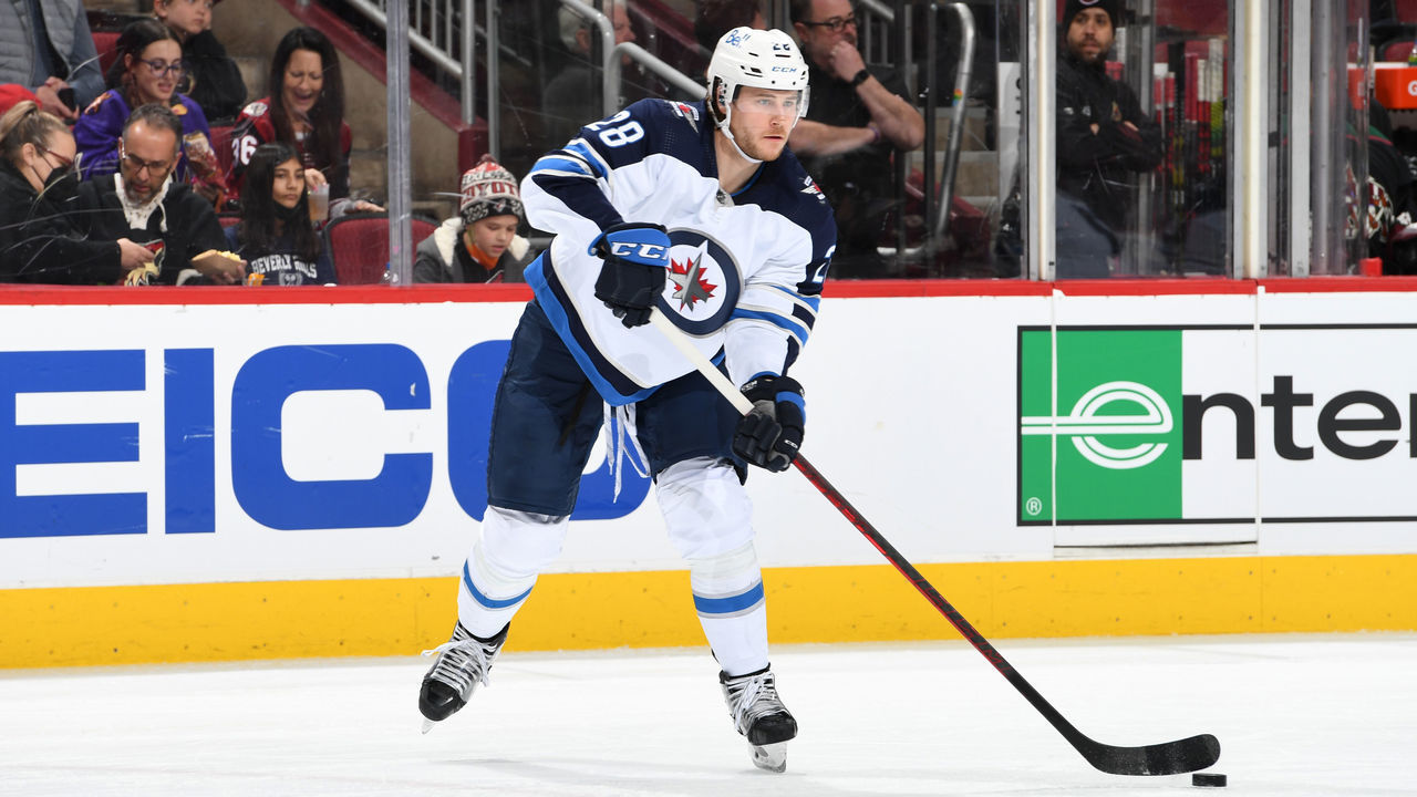 GLENDALE, ARIZONA - FEBRUARY 27: Nathan Beaulieu #28 of the Winnipeg Jets passes the puck against the Arizona Coyotes at Gila River Arena on February 27, 2022 in Glendale, Arizona.