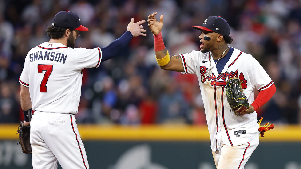 ATLANTA, GA - OCTOBER 01: Dansby Swanson #7 and Ronald Acuna Jr. #13 of the Atlanta Braves celebrate the 4-2 victory over the New York Mets at Truist Park on October 1, 2022 in Atlanta, Georgia.