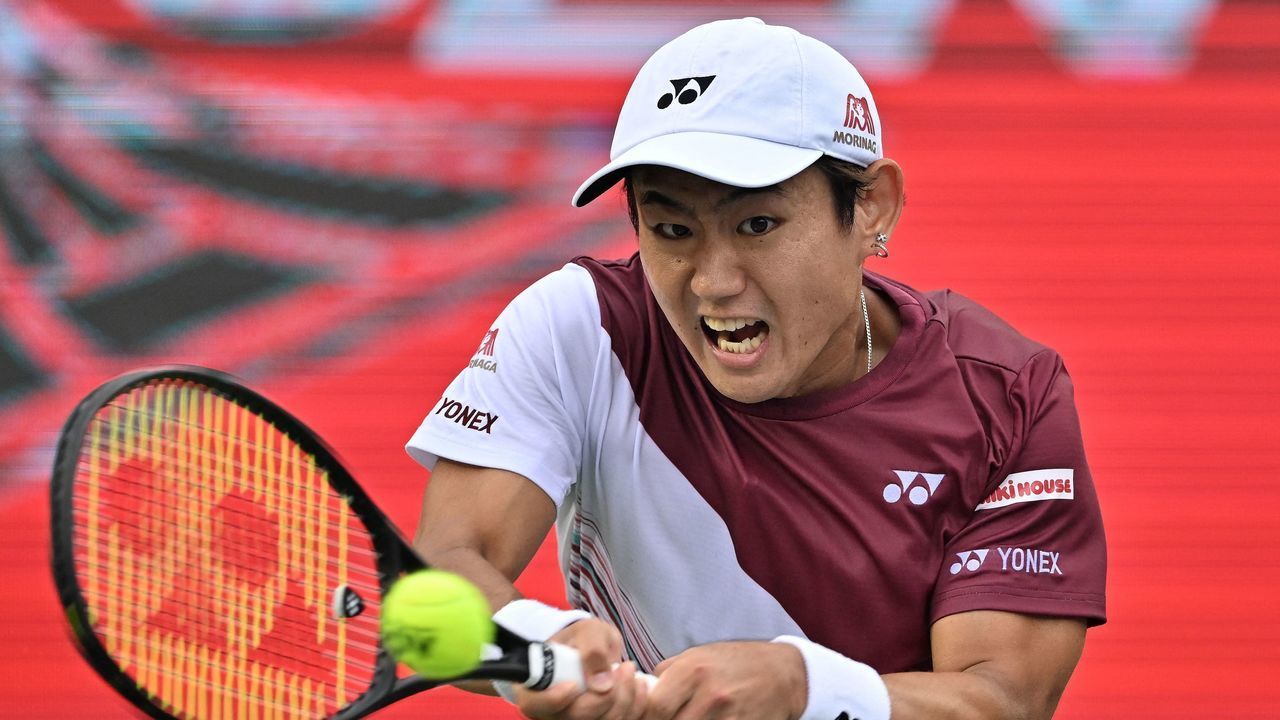 Yoshihito Nishioka of Japan hits a return against Denis Shapovalov of Canada during their mens singles final match at the Korea Open Tennis Championships in Seoul on October 2, 2022.