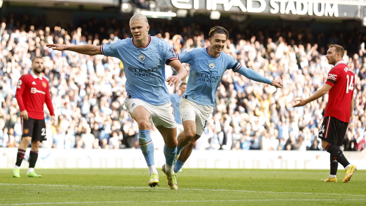 MANCHESTER, ENGLAND - OCTOBER 02: Erling Haaland of Manchester City celebrates their sides fifth goal and their hat trick with team mate Jack Grealish during the Premier League match between Manchester City and Manchester United at Etihad Stadium on October 02, 2022 in Manchester, England.