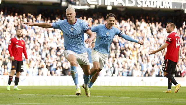 MANCHESTER, ENGLAND - OCTOBER 02: Erling Haaland of Manchester City celebrates their sides fifth goal and their hat trick with team mate Jack Grealish during the Premier League match between Manchester City and Manchester United at Etihad Stadium on October 02, 2022 in Manchester, England.
