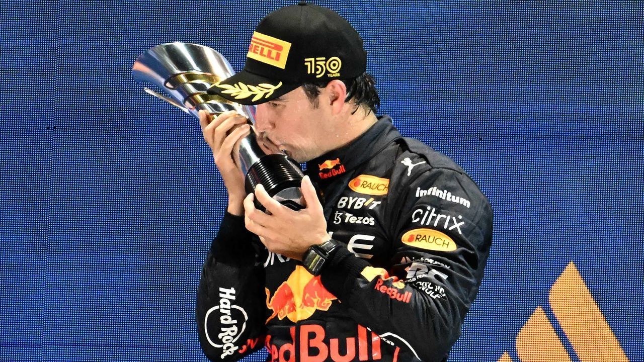 Winner Red Bull Racing's Mexican driver Sergio Perez celebrates on the podium after the Formula One Singapore Grand Prix night race at the Marina Bay Street Circuit in Singapore on October 2, 2022.