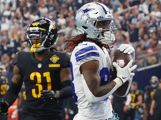 ARLINGTON, TEXAS - OCTOBER 02: CeeDee Lamb #88 of the Dallas Cowboys scores a touchdown during the fourth quarter against the Washington Commanders at AT&T Stadium on October 02, 2022 in Arlington, Texas.