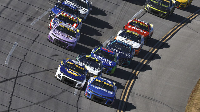 TALLADEGA, ALABAMA - OCTOBER 02: Kyle Larson, driver of the #5 HendrickCars.com Chevrolet, and Chase Elliott, driver of the #9 NAPA Auto Parts Chevrolet, lead the field during the NASCAR Cup Series YellaWood 500 at Talladega Superspeedway on October 02, 2022 in Talladega, Alabama.
