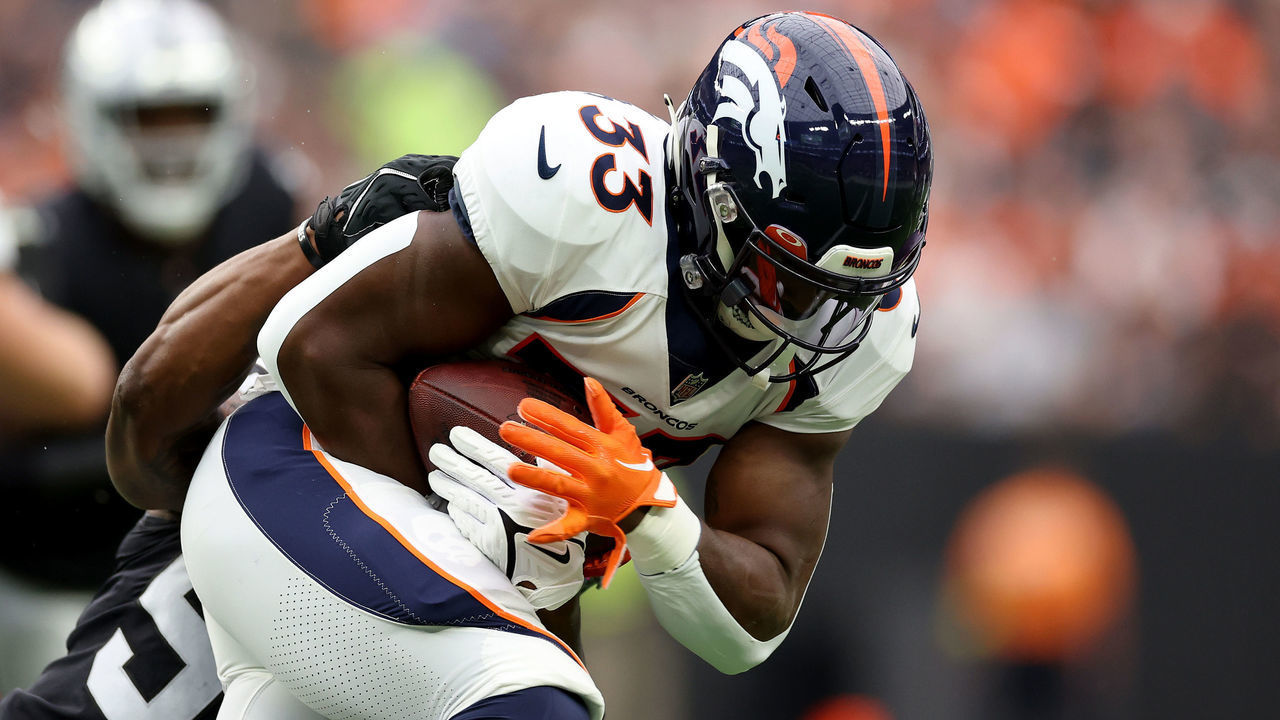 LAS VEGAS, NEVADA - OCTOBER 02: Javonte Williams #33 of the Denver Broncos runs with the ball while being tackled by Chandler Jones #55 of the Las Vegas Raiders in the first quarter at Allegiant Stadium on October 02, 2022 in Las Vegas, Nevada.