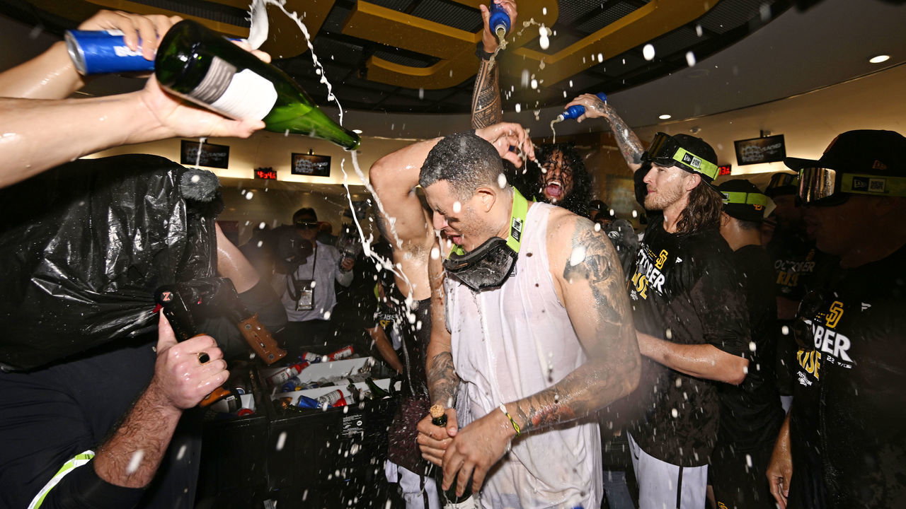 SAN DIEGO, CA - OCTOBER 2: Manny Machado #13 of the San Diego Padres is doused with champagne after the Padres played the Chicago White Sox in a baseball game October 2, 2022 at Petco Park in San Diego, California. The Padres clinched a playoff spot after the Milwaukee Brewers lost to the Miami Marlins.