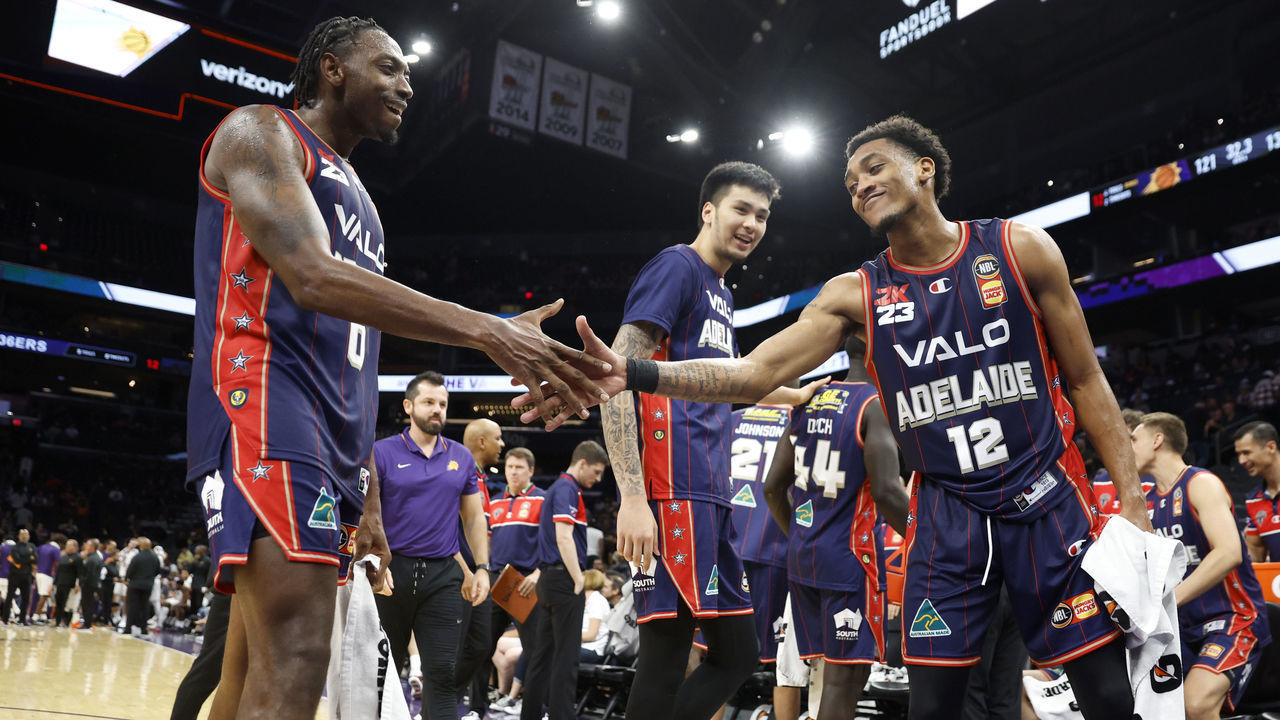 PHOENIX, ARIZONA - OCTOBER 02: Craig Randall II #12 shakes hands with Robert Franks #0 of the Adelaide 36ers during the second half against the Phoenix Suns at Footprint Center on October 02, 2022 in Phoenix, Arizona. The 36ers beat the Suns 134-124.