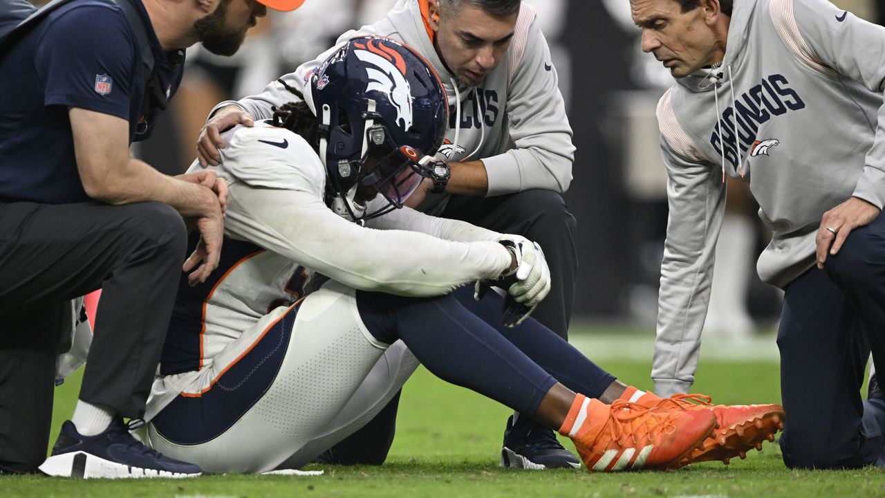LAS VEGAS, NEVADA - OCTOBER 2: Staff looks at Denver Broncos linebacker Randy Gregory (5) after he got hurt during the game at Allegiant Stadium on October 2, 2022 in Las Vegas, Nevada. The home team Las Vegas Raiders won 32-23 over the Denver Broncos during week four of the NFL season.
