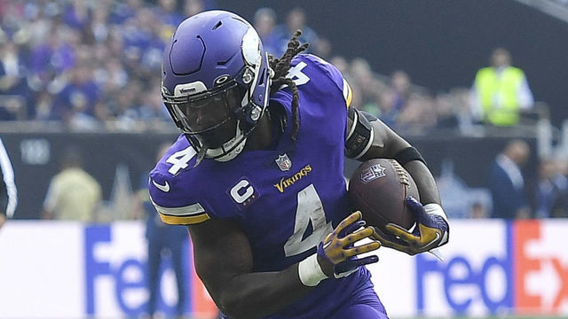 LONDON, ENGLAND - OCTOBER 02: Pete Wernerof New Orleans Saints and Dalvin Cook of Minnesota Vikings battle for the ball during the NFL match between Minnesota Vikings v New Orleans Saints at Tottenham Hotspur Stadium on October 2, 2022 in London, England.