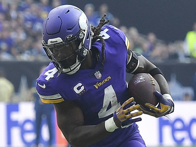 LONDON, ENGLAND - OCTOBER 02: Pete Wernerof New Orleans Saints and Dalvin Cook of Minnesota Vikings battle for the ball during the NFL match between Minnesota Vikings v New Orleans Saints at Tottenham Hotspur Stadium on October 2, 2022 in London, England.