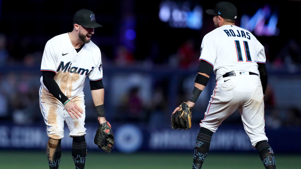 MIAMI, FLORIDA - OCTOBER 03: Jon Berti #5 and Miguel Rojas #11 of the Miami Marlins celebrate after defeating the Atlanta Braves at loanDepot park on October 03, 2022 in Miami, Florida.