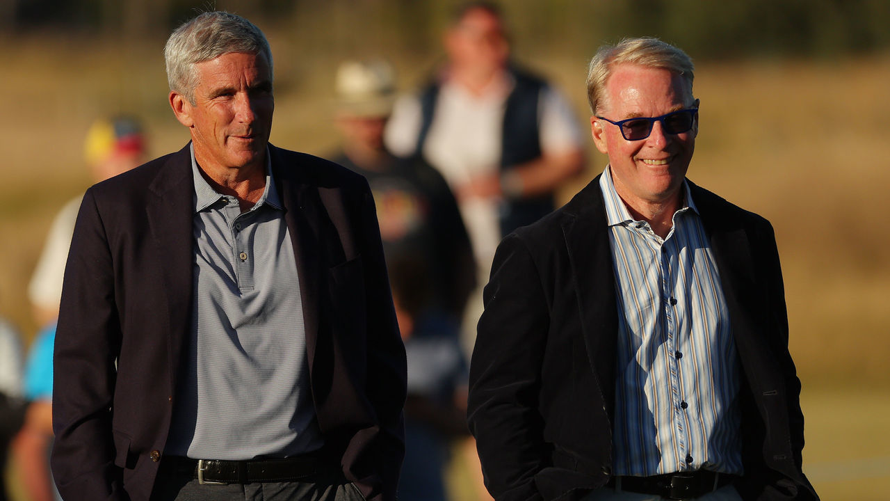 NORTH BERWICK, SCOTLAND - JULY 10: European Tour CEO Keith Pelley (R) and PGA Tour Commissioner Jay Monahan look on on the 18th green during Day Four of the Genesis Scottish Open at The Renaissance Club on July 10, 2022 in North Berwick, Scotland.