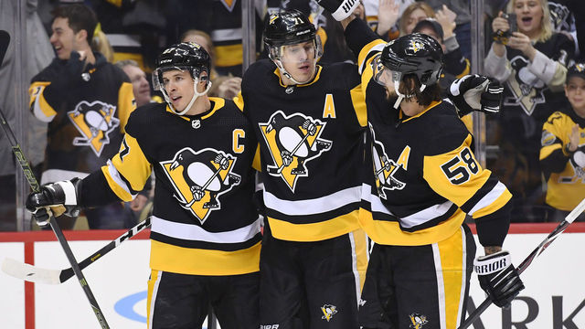 PITTSBURGH, PA - FEBRUARY 16: Pittsburgh Penguins Center Sidney Crosby (87) celebrates his power play goal with Pittsburgh Penguins Center Evgeni Malkin (71) and Pittsburgh Penguins Defenseman Kris Letang (58) during the second period in the NHL game between the Pittsburgh Penguins and the Calgary Flames on February 16, 2019, at PPG Paints Arena in Pittsburgh, PA.