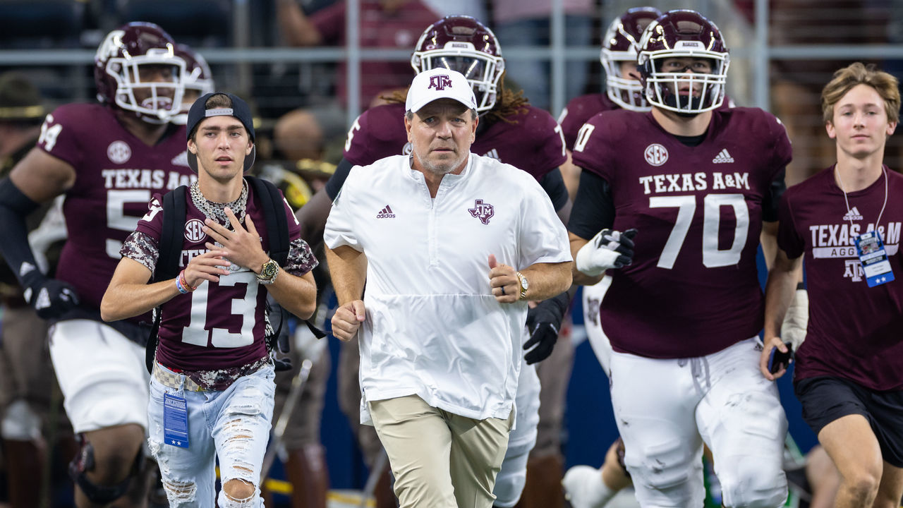 ARLINGTON, TX - SEPTEMBER 24: Texas A&M Aggies head coach Jimbo Fisher leads his team onto he field during the Southwest Classic college football game between the Texas A&M Aggies and the Arkansas Razorbacks on September 24, 2022 at AT&T Stadium in Arlington, TX.