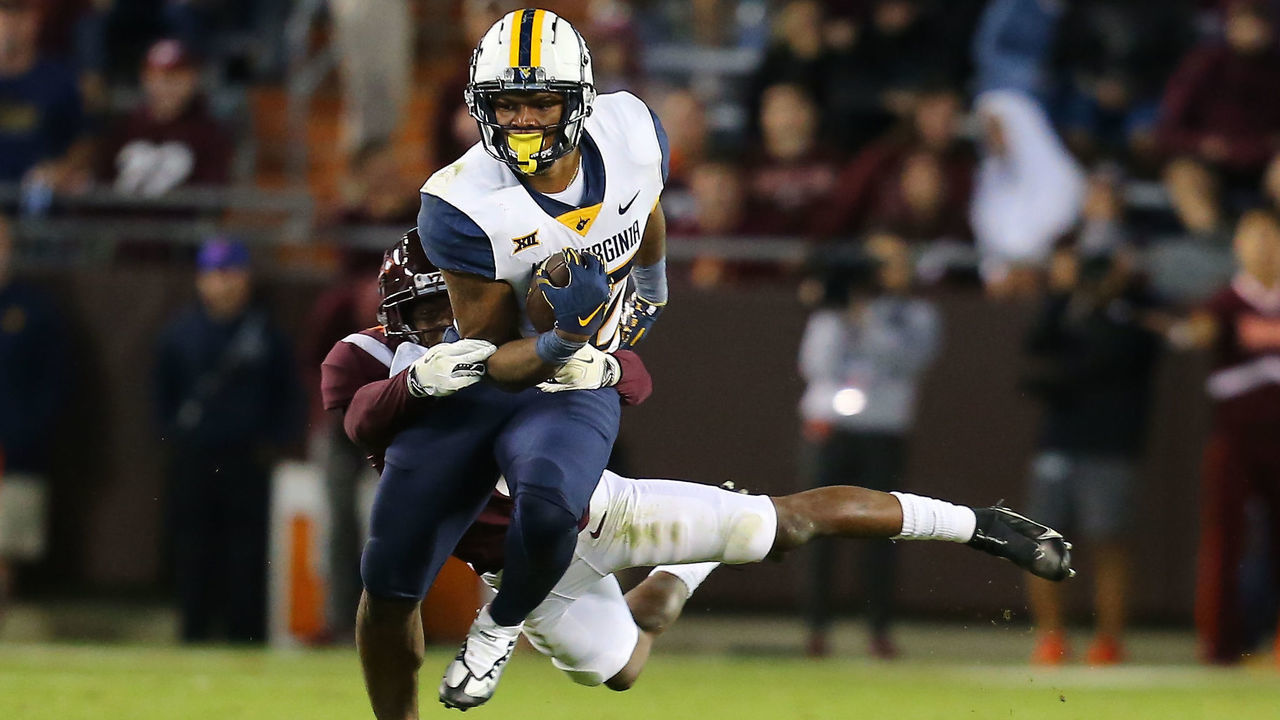 BLACKSBURG, VA - SEPTEMBER 22: West Virginia Mountaineers tight end CJ Donaldson Jr. (12) rushes up field while attempting to avoid Virginia Tech Hokies defensive back Chamarri Conner (25) during a college football game between the West Virginia Mountaineers and the Virginia Tech Hokies on September 22, 2022, at Lane Stadium in Blacksburg, VA.