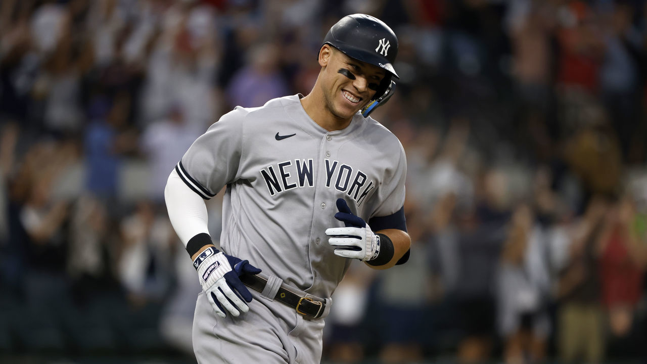 ARLINGTON, TX - OCTOBER 4: Aaron Judge #99 of the New York Yankees smiles as he rounds the bases after hitting his 62nd home run of the season against the Texas Rangers during the first inning in game two of a double header at Globe Life Field on October 4, 2022 in Arlington, Texas. Judge has now set the American League record for home runs in a single season.