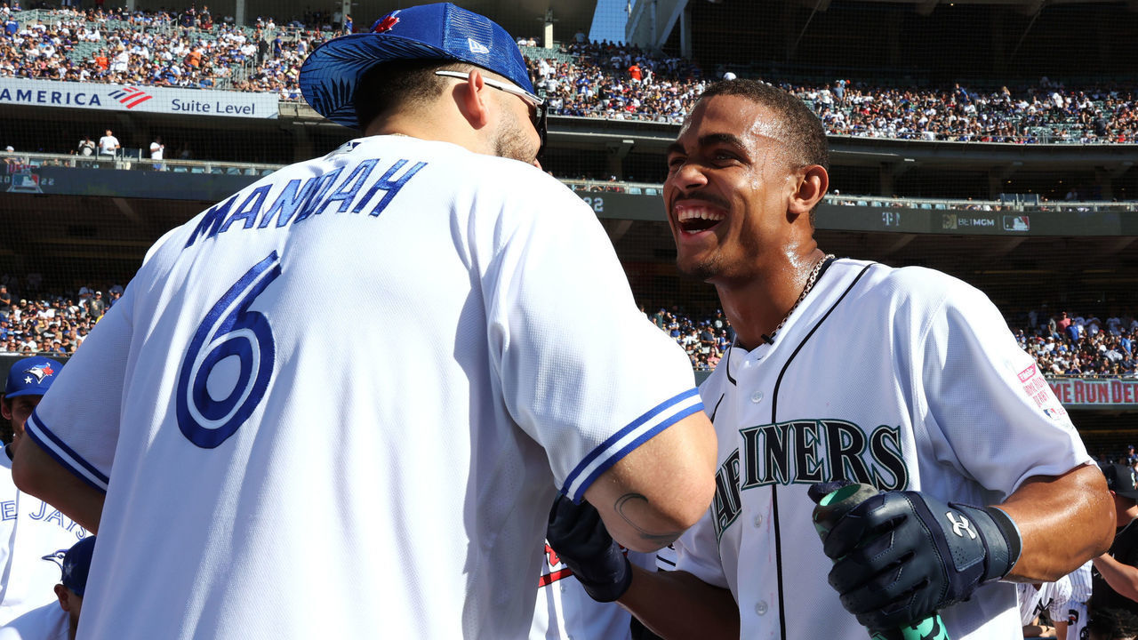 LOS ANGELES, CA - JULY 18: Julio Rodríguez #44 of the Seattle Mariners is congratulated by Alek Manoah #6 of the Toronto Blue Jays after the first round during the T-Mobile Home Run Derby at Dodger Stadium on Monday, July 18, 2022 in Los Angeles, California.