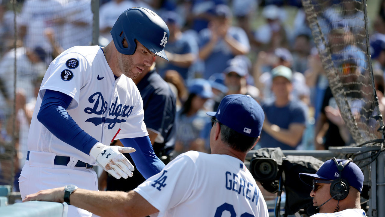 LOS ANGELES, CALIFORNIA - OCTOBER 05: Freddie Freeman #5 of the Los Angeles Dodgers celebrates his solo homerun with Bob Geren #88 and Dave Roberts #30, to tie the game 1-1 with the Colorado Rockies, during the third inning at Dodger Stadium on October 05, 2022 in Los Angeles, California.