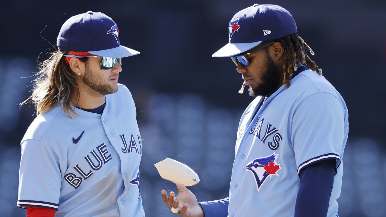 CLEVELAND, OH - MAY 07: Toronto Blue Jays first baseman Vladimir Guerrero Jr. (27) and shortstop Bo Bichette (11) talk during game one of an MLB doubleheader against the Cleveland Guardians on May 7, 2022 at Progressive Field in Cleveland, Ohio.