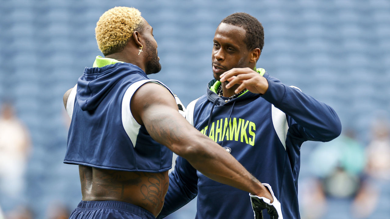 SEATTLE, WASHINGTON - AUGUST 18: DK Metcalf #14 hugs Geno Smith #7 of the Seattle Seahawks prior to the preseason game against the Chicago Bears at Lumen Field on August 18, 2022 in Seattle, Washington.