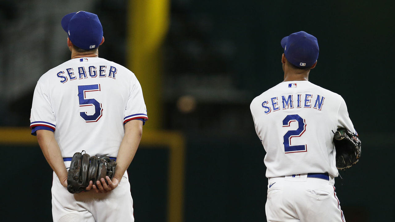 ARLINGTON, TEXAS - AUGUST 06: Corey Seager #5 of the Texas Rangers and Marcus Semien #2 watch a replay in the ninth inning of the game against the Chicago White Sox at Globe Life Field on August 06, 2022 in Arlington, Texas.