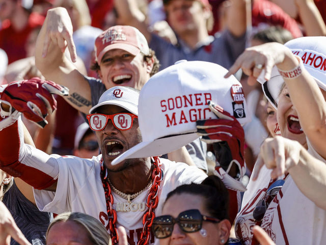 DALLAS, TX - OCTOBER 09: Oklahoma Sooners fans cheer for their team during the Red River Showdown between the Texas Longhorns and the Oklahoma Sooners on October 09, 2021 at the Cotton Bowl in Dallas, Texas.