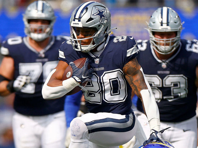 INGLEWOOD, CALIFORNIA - OCTOBER 09: Tony Pollard #20 of the Dallas Cowboys runs for a touchdown against Nick Scott #33 of the Los Angeles Rams during the second quarter at SoFi Stadium on October 09, 2022 in Inglewood, California.