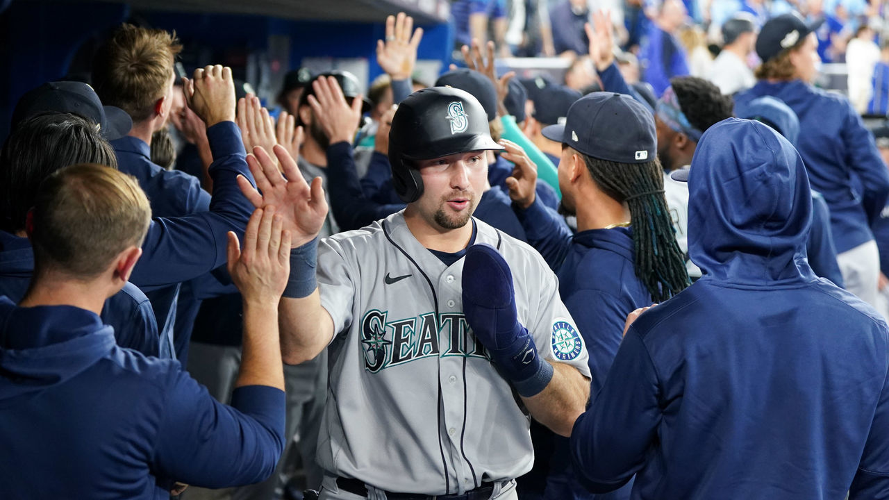 TORONTO, - OCTOBER 08: Cal Raleigh #29 of the Seattle Mariners high-fives teammates in the dugout after scoring in the eighth inning during the Wild Card Series game between the Seattle Mariners and the Toronto Blue Jays at Rogers Centre on Saturday, October 8, 2022 in Toronto, Canada.