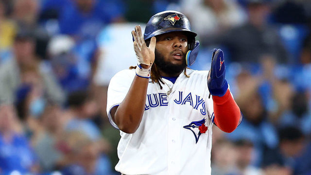 TORONTO, ON - SEPTEMBER 13: Vladimir Guerrero Jr. #27 of the Toronto Blue Jays applauds as Bo Bichette #11 hits a single in the eighth inning during game one of a doubleheader against the Tampa Bay Rays at Rogers Centre on September 13, 2022 in Toronto, Ontario, Canada.