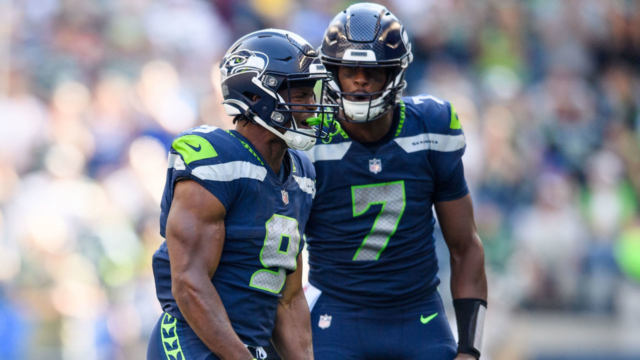 SEATTLE, WASHINGTON - SEPTEMBER 25: Kenneth Walker III #9 of the Seattle Seahawks reacts with Geno Smith #7 during the second half of the game against the Atlanta Falcons at Lumen Field on September 25, 2022 in Seattle, Washington.
