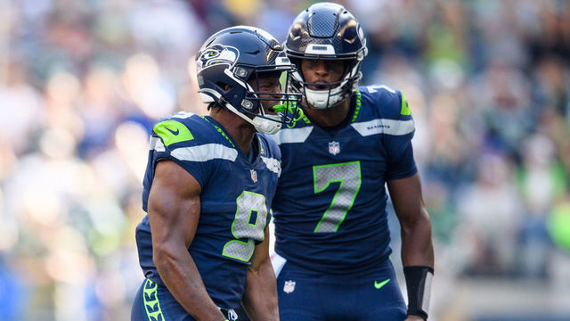 SEATTLE, WASHINGTON - SEPTEMBER 25: Kenneth Walker III #9 of the Seattle Seahawks reacts with Geno Smith #7 during the second half of the game against the Atlanta Falcons at Lumen Field on September 25, 2022 in Seattle, Washington.