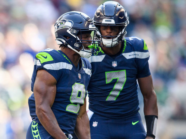 SEATTLE, WASHINGTON - SEPTEMBER 25: Kenneth Walker III #9 of the Seattle Seahawks reacts with Geno Smith #7 during the second half of the game against the Atlanta Falcons at Lumen Field on September 25, 2022 in Seattle, Washington.