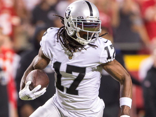 KANSAS CITY, MO - OCTOBER 10: Las Vegas Raiders wide receiver Davante Adams (17) runs the ball around Kansas City Chiefs cornerback Rashad Fenton (27) during the first half on October 10th, 2022 at GEHA field in Kansas City, Missouri.
