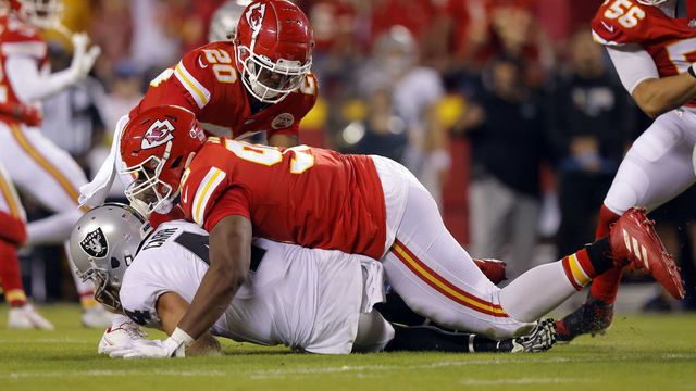 KANSAS CITY, MISSOURI - OCTOBER 10: Derek Carr #4 of the Las Vegas Raiders is sacked by Chris Jones #95 of the Kansas City Chiefs during the 2nd quarter of the game at Arrowhead Stadium on October 10, 2022 in Kansas City, Missouri. Jones was called for a penalty for roughing the passer.