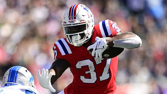 FOXBOROUGH, MASSACHUSETTS - OCTOBER 09: Damien Harris #37 of the New England Patriots runs past DeShon Elliott #5 of the Detroit Lions during the first quarter at Gillette Stadium on October 09, 2022 in Foxborough, Massachusetts.