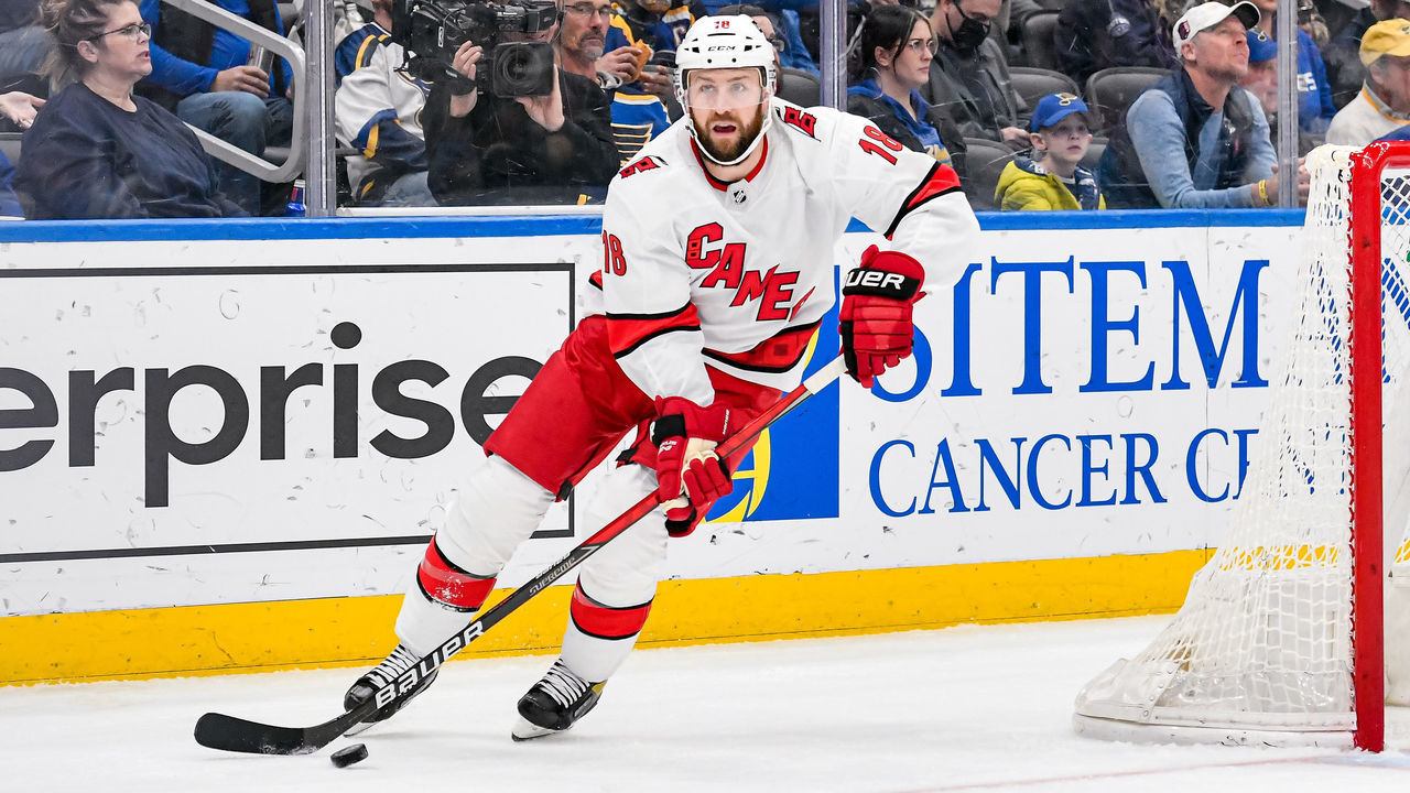 ST. LOUIS, MO - MARCH 26: Carolina Hurricanes center Derek Stepan (18) passes the puck out from behind his own net during a game between the Carolina Hurricanes and the St. Louis Blues on March 26, 2022, at the Enterprise Center in St. Louis MO