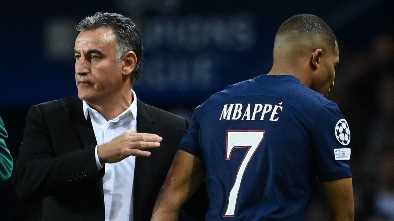 Paris Saint-Germain's French forward Kylian Mbappe (R) leaves the pitch after he is substituted by Paris Saint-Germain's French head coach Christophe Galtier (L) during the UEFA Champions League group H football match between Paris Saint-Germain (PSG) and SL Benfica, at The Parc des Princes Stadium, on October 11, 2022.