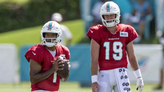 MIAMI GARDENS, FL - AUGUST 06: Miami Dolphins quarterback Tua Tagovailoa (1) throws the ball in front of Miami Dolphins quarterback Skylar Thompson (19) during a practice session at the Miami Dolphins training camp at Baptist Health Training Complex on August 6, 2022 in Miami Gardens, Florida.