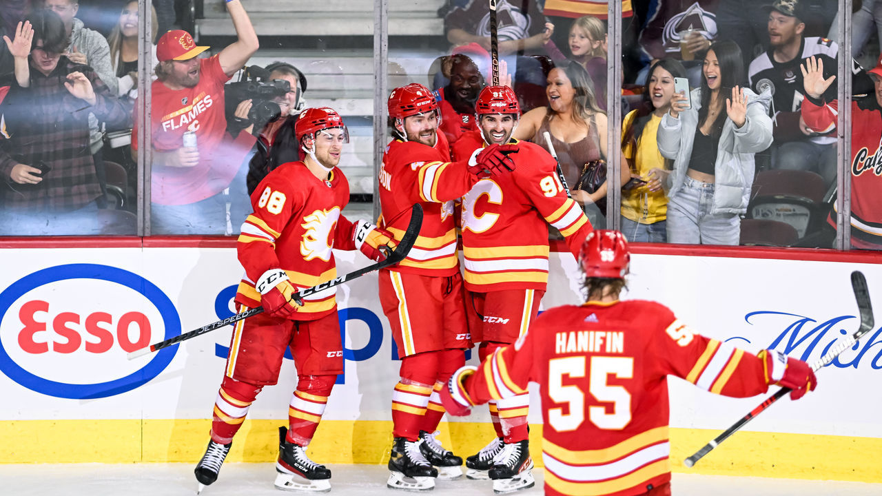 CALGARY, AB - OCTOBER 13: Calgary Flames Defenceman Rasmus Andersson (4) celebrates a goal with Calgary Flames Right Wing Andrew Mangiapane (88), Calgary Flames Center Nazem Kadri (91) and Calgary Flames Defenceman Noah Hanifin (55) during the second period of an NHL game between the Calgary Flames and the Colorado Avalanche on October 13, 2022, at the Scotiabank Saddledome in Calgary, AB.