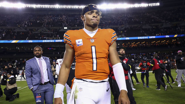 CHICAGO, IL - OCTOBER 13: Justin Fields #1 of the Chicago Bears walks off the field dejected after an NFL football game against the Washington Commanders at Soldier Field on October 13, 2022 in Chicago, Illinois.