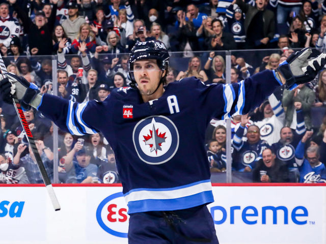 WINNIPEG, CANADA - OCTOBER 14: Mark Scheifele #55 of the Winnipeg Jets celebrates after scoring a first period goal against the New York Rangers at the Canada Life Centre on October 14, 2022 in Winnipeg, Manitoba, Canada.