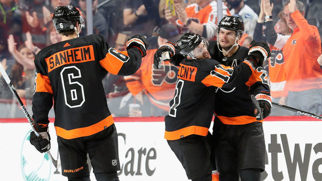 PHILADELPHIA, PENNSYLVANIA - OCTOBER 15: Scott Laughton #21 of the Philadelphia Flyers celebrates his second period shorthanded goal against the Vancouver Canucks with Travis Sanheim #6 and Travis Konecny #11 at the Wells Fargo Center on October 15, 2022 in Philadelphia, Pennsylvania.