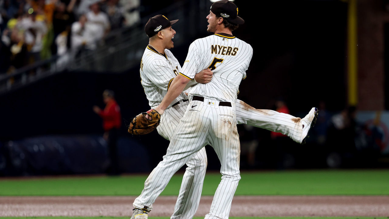 SAN DIEGO, CA - OCTOBER 15: Manny Machado #13 and Wil Myers #5 of the San Diego Padres celebrate after the Padres defeated the Los Angeles Dodgers at Petco Park on Saturday, October 15, 2022 in San Diego, California.
