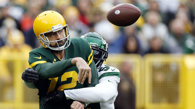 GREEN BAY, WISCONSIN - OCTOBER 16: Aaron Rodgers #12 of the Green Bay Packers while throwing a pass during the first quarter a game against the New York Jets at Lambeau Field on October 16, 2022 in Green Bay, Wisconsin.