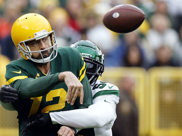 GREEN BAY, WI - OCTOBER 16: Green Bay Packers quarterback Aaron Rodgers  (12) passes during a game between the Green Bay Packers and the New York  Jets at Lambeau Field on October