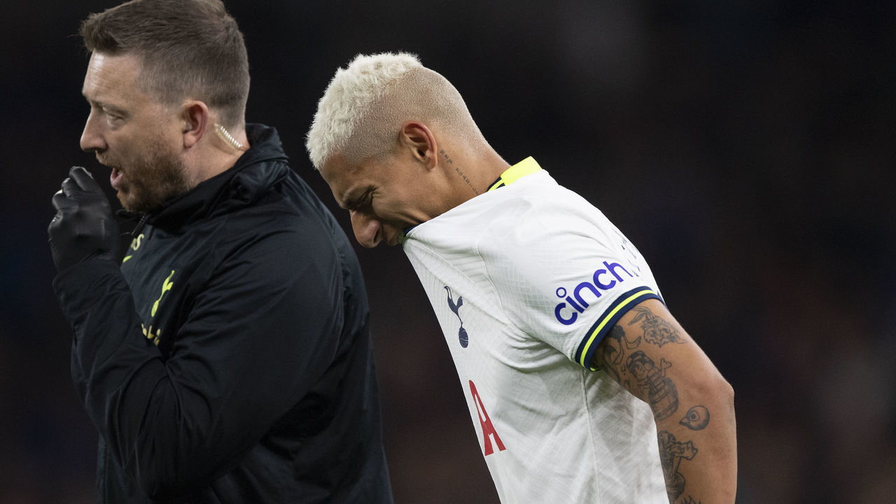 LONDON, ENGLAND - OCTOBER 15: Richarlison of Tottenham Hotspur walks off the pitch with a member of the Tottenham medical staff after picking up an injury to his injured left calf during the Premier League match between Tottenham Hotspur and Everton FC at Tottenham Hotspur Stadium on October 15, 2022 in London, England.
